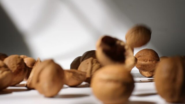 Slow motion of walnut nuts on table