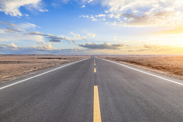 Asphalt highway road and desert sand ground with sky clouds natural landscape at sunset. Road trip.