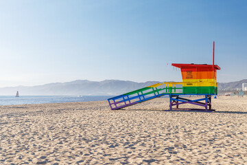 Vibrant lifeguard tower painted in LGBTQ rainbow colors