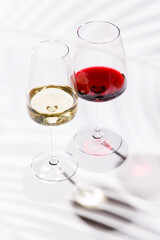 Two wine glasses filled with red and white wine