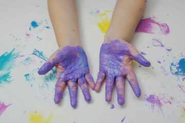 Colorful painted hands of child on white background, expressing creativity