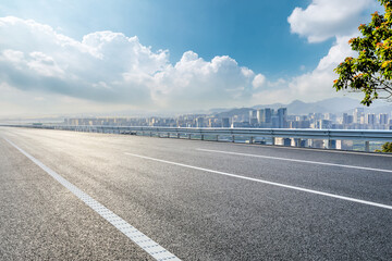 Fototapeta premium Asphalt highway road and city skyline with modern buildings scenery in Shenzhen. Outdoor road background.