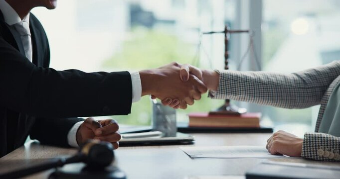 Hands, attorney and handshake with paperwork in office, agreement and review for compliance at company. People, lawyer and documents with consultation, contract and thank you at corporate law firm