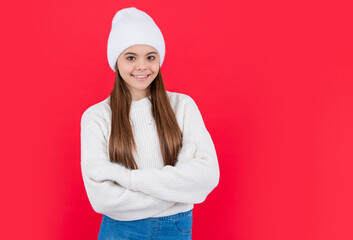 happy teen girl in warm winter knitwear sweater and mittens with copy space.