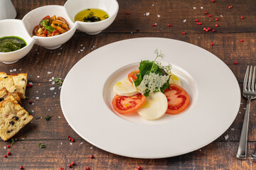Tomato and mozzarella salad on a white porcelain plate, Caprese Salad