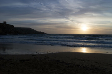 Stunning sunset over sea in Golden Bay Malta.