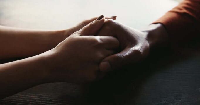 Love, trust and support with couple and holding hands for care, empathy and sympathy. Comfort, partner and gratitude with closeup of people at home for helping, solidarity and kindness together