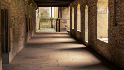 Historic Stone Corridor with Arched Windows
