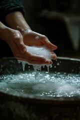 Fototapeta premium Hands cupping suds over bubbly water.