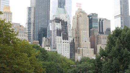 New York City Manhattan Midtown. Central park on 5th Fifth 5 avenue, USA. American landmark, urban public park in NYC, United States. Skyscraper buildings architecture, 59 street skyline. Green trees.