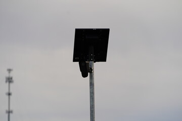 Flock safety police law enforcement license plate reader set up outside to help catch vehicle speeders.