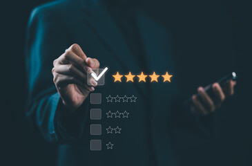 Hand touching and doing mark to five yellow stars on black background, the best customer satisfaction and evaluation for good quality product and service.
