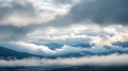 Obraz premium Majestic mountain landscape shrouded in mist during early morning light