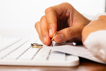 woman hands removing a ring from their finger with a document on the table, symbolize a significant life change, a decision to separate or end a relationship, divorce