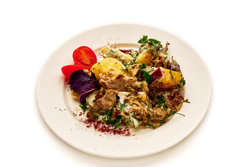 A plate of food with a variety of vegetables and meat