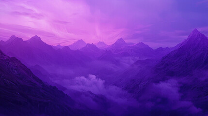 Fototapeta premium Purple mountain range with misty valleys at sunset.