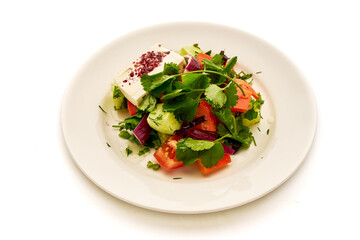 A plate of salad with tomatoes, cucumbers, and onions