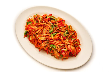 A plate of food with a variety of vegetables including carrots and peppers