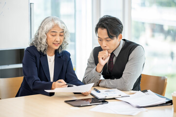 Executives are having a meeting with employees to discuss business planning in a conference room.