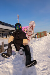 snowboarder with glasses sitting on the snow