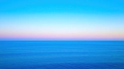 Fototapeta premium Calming Ocean Sunset: Serene Blue Horizon for Relaxation and Meditation