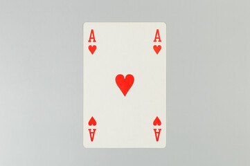 Top view of playing cards on grey background. One ace card, board game, poker. Copy space, flat lay.
