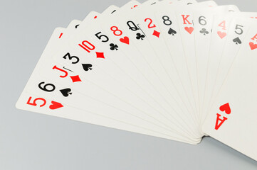 Top view of playing cards on grey background. Board game, poker. Copy space, flat lay.