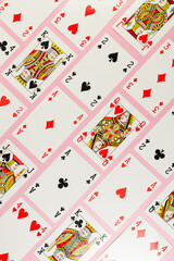 Top view of playing cards on pink background. Lot of cards, board game, poker. Copy space, flat lay.