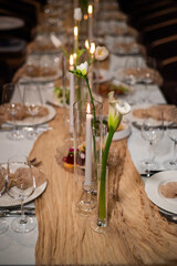 beautiful table setting with flowers and cutlery on wooden table at wedding or dinner. stylish tablewear decorations	