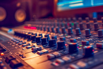 Obraz premium Sound engineer's mixing console in a professional recording studio with ambient lighting