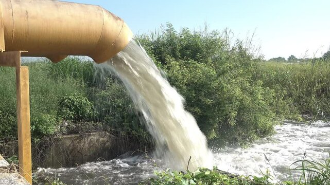 Dirty polluted water flows out of the pipe. Sewage.