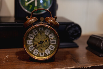 antique pocket clock on wooden table, vintage clock in brown color