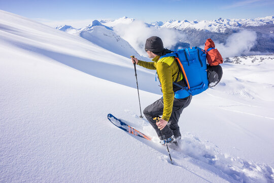 skier uses skins to ascend a peak on the Spearhead Traverse, Whistler
