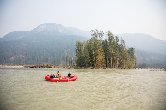 Men on raft on the Squamish River, British Columbia, Canada.