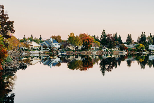Serene lakefront neighborhood with colorful fall trees