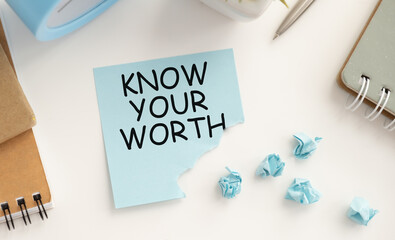 Know Your Worth text on a card on a clip on a notebook, a business concept