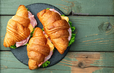 Croissant sandwich with salad ham and cheese . Top view