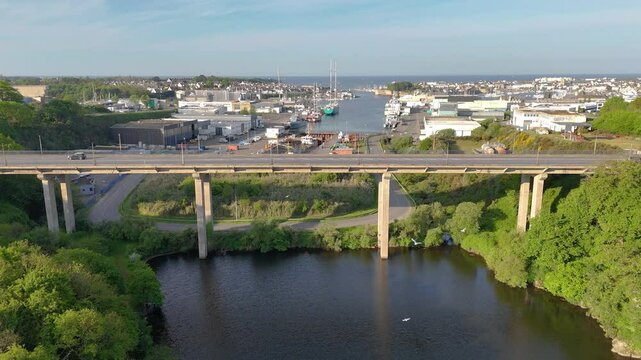 Drone view Moros Lagoon, Concarneau, France, showing calm waters mand small castle, lush trees, vibrant blue sky with clouds, ideal for nature, relaxation, travel projects.from up