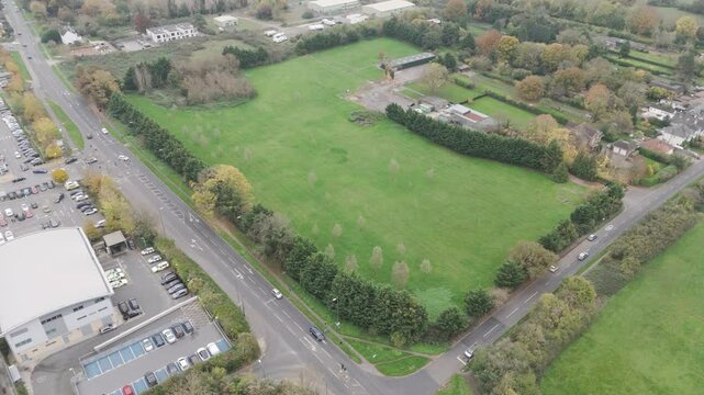 Aerial view of a corner plot of green field land in Berkshire, prepared for future residential redevelopment in the United Kingdom