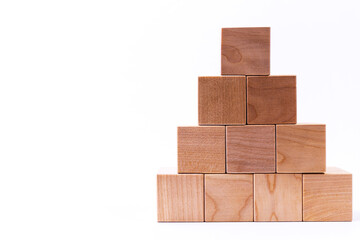 Wooden cubes in the form of a pyramid. Financial pyramid. copy space.