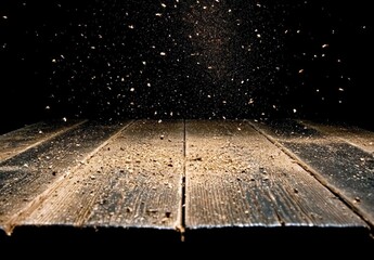 Dust and wood chips on a black background