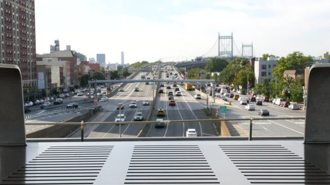 Triborough Bridge in Astoria, Robert F. Kennedy Bridge, New York City. Car traffic on road, multiple lane transport highway from elevated subway station in Queens near Ditmars Steinway, NYC, USA.