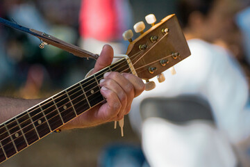 hand gripping spanish guitar neck, creating music