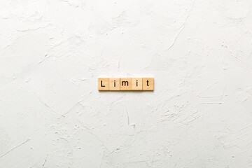 limit word written on wood block. limit text on table, concept