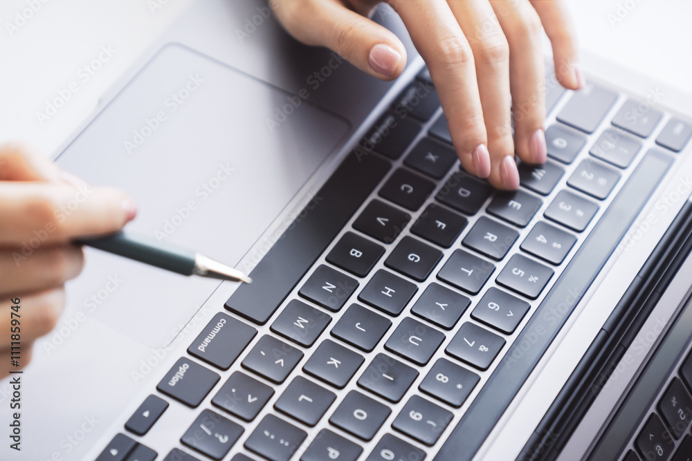 Poster a close view of a woman's hands typing on a modern laptop keyboard, office surroundings appearing fu