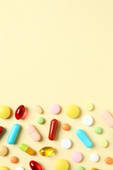 Various pills and capsules on a color background