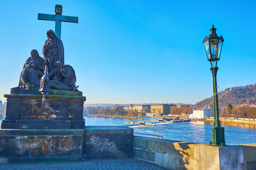 Pieta statue on Charles Bridge against the Vltava, Prague, Czechia