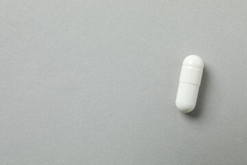 Medicine capsule on gray background 
