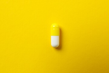 Medicine capsule on color background 