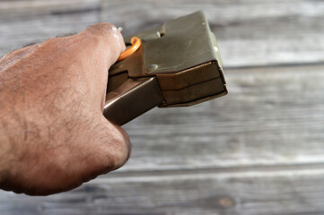 manual staple gun, powered stapler is a hand-held machine used to drive heavy metal staples into wood and plastic, commonly used in furniture, mostly to fix fabric on the wood, selective focus